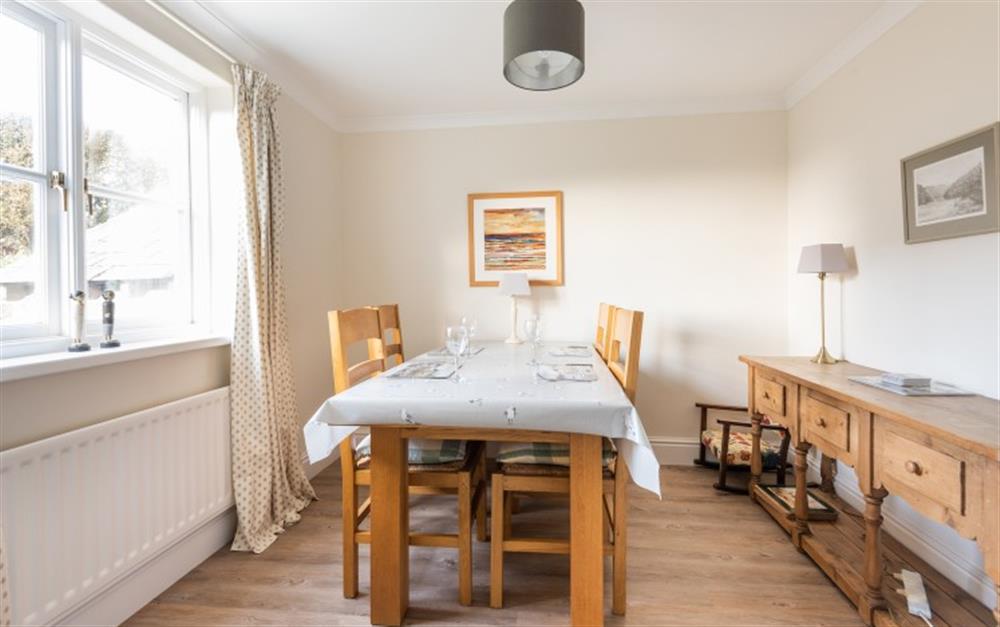 Separate dining room with table and chairs for 4 at Clock Cottage in Dittisham