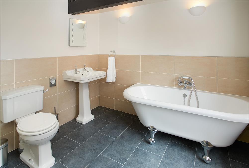 Bathroom with roll top bath and separate, walk-in shower at Clock Tower Apartment, Netherby Hall, Longtown
