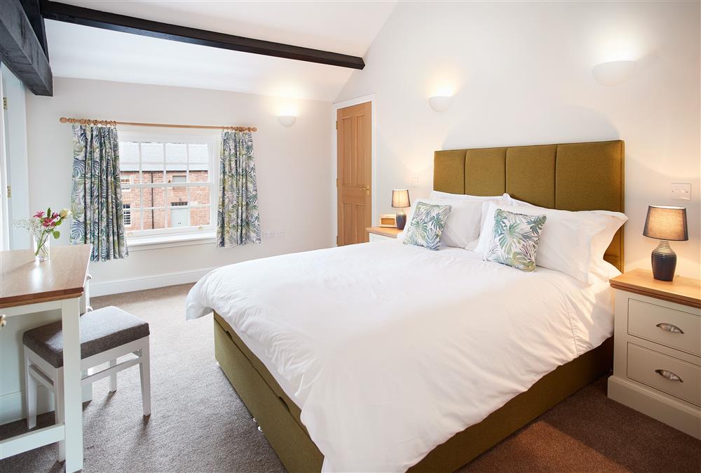 Bedroom with a 5’ king-size bed at Clock Tower Apartment, Netherby Hall, Longtown