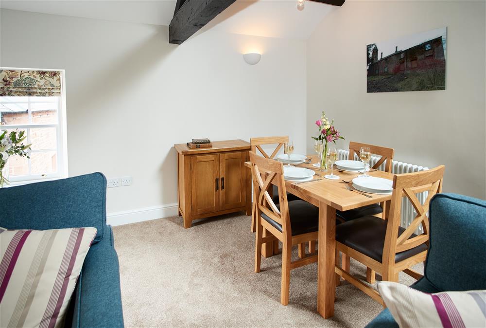 Dining area with seating for four guests at Clock Tower Apartment, Netherby Hall, Longtown