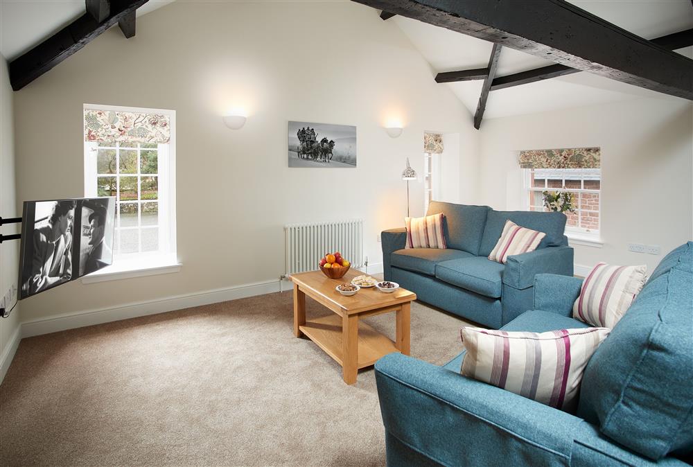 Open-plan sitting room to relax and watch television at Clock Tower Apartment, Netherby Hall, Longtown