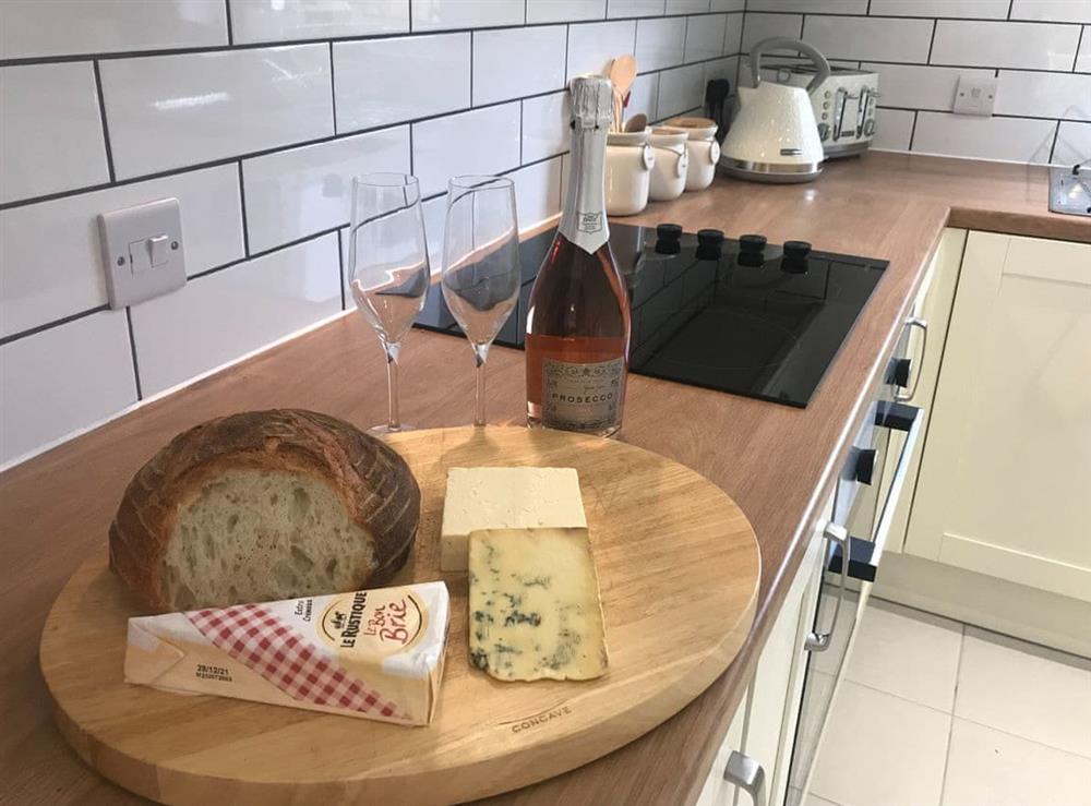 Kitchen -cheese and wine at Clock Tower Cottage in Whitchurch, Herefordshire