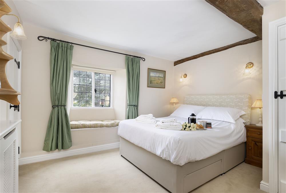 Bedroom two with a king-size bed and window seat to enjoy the view at Closes Farm Cottage, Broadway