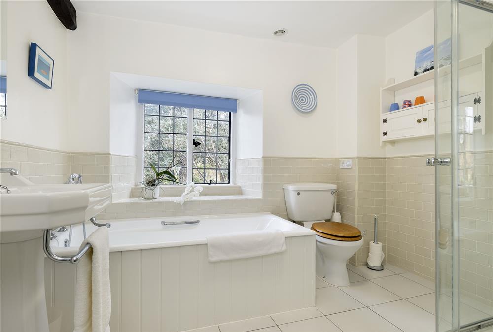 Family bathroom with a bath and separate shower at Closes Farm Cottage, Broadway
