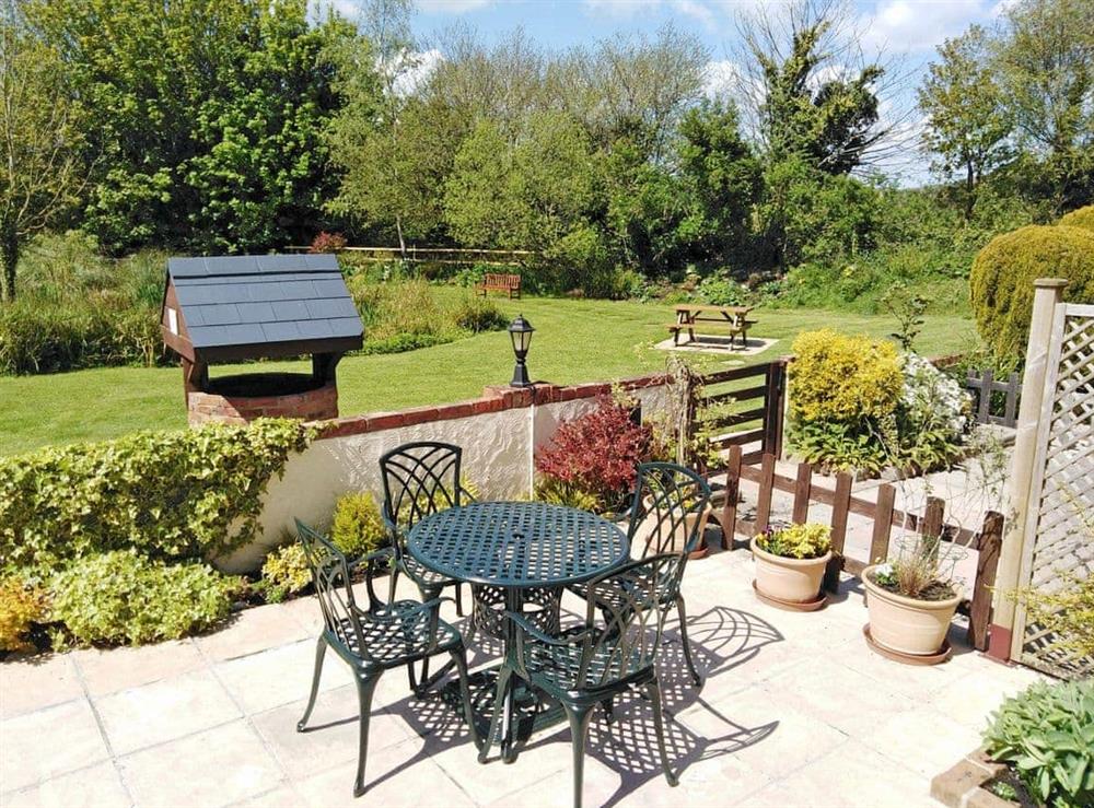 Relaxing patio area with garden furniture at Clouseau Cottage in Lyme Regis, Dorset., Great Britain