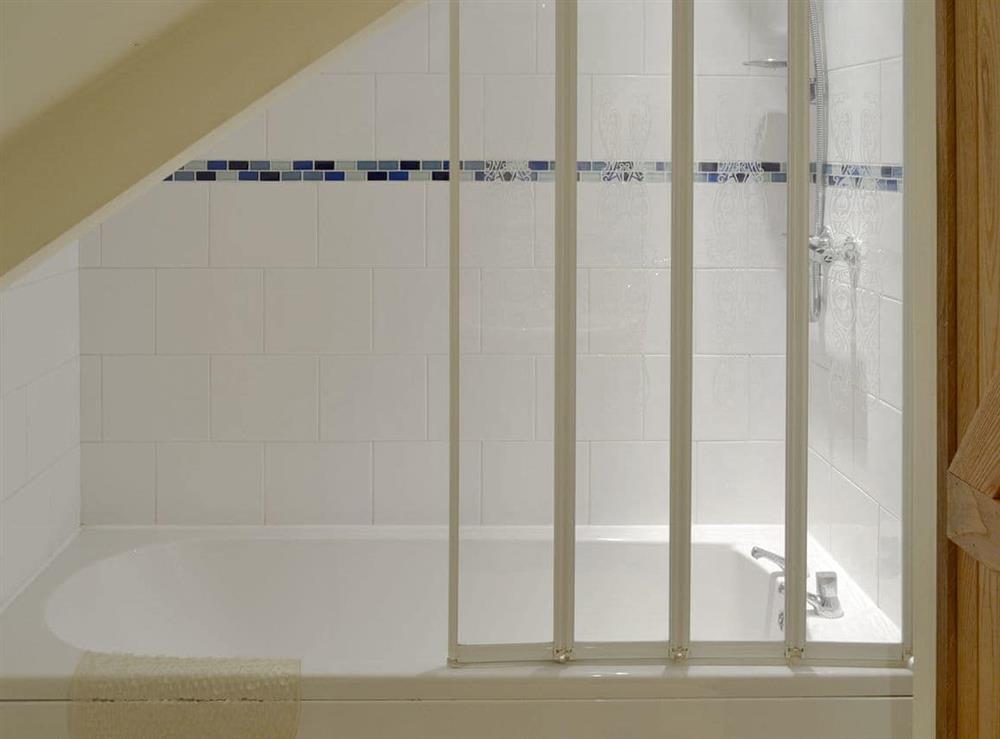 Bathroom with shower over bath at Clyst William Barn in Plymtree, Cullompton, Devon