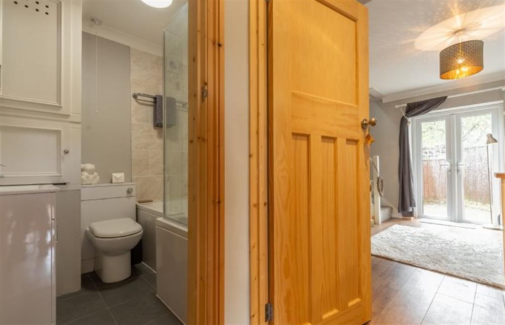Ground floor: Bathroom with bath and shower over, wash basin and WC at Coach House Cottage, Weybourne near Holt