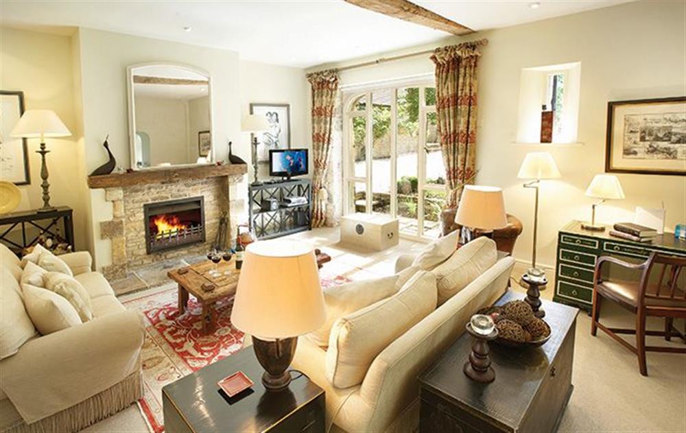 Ground floor: Open plan sitting room with open fire, dining and kitchen at Coach House (Hawling), Hawling