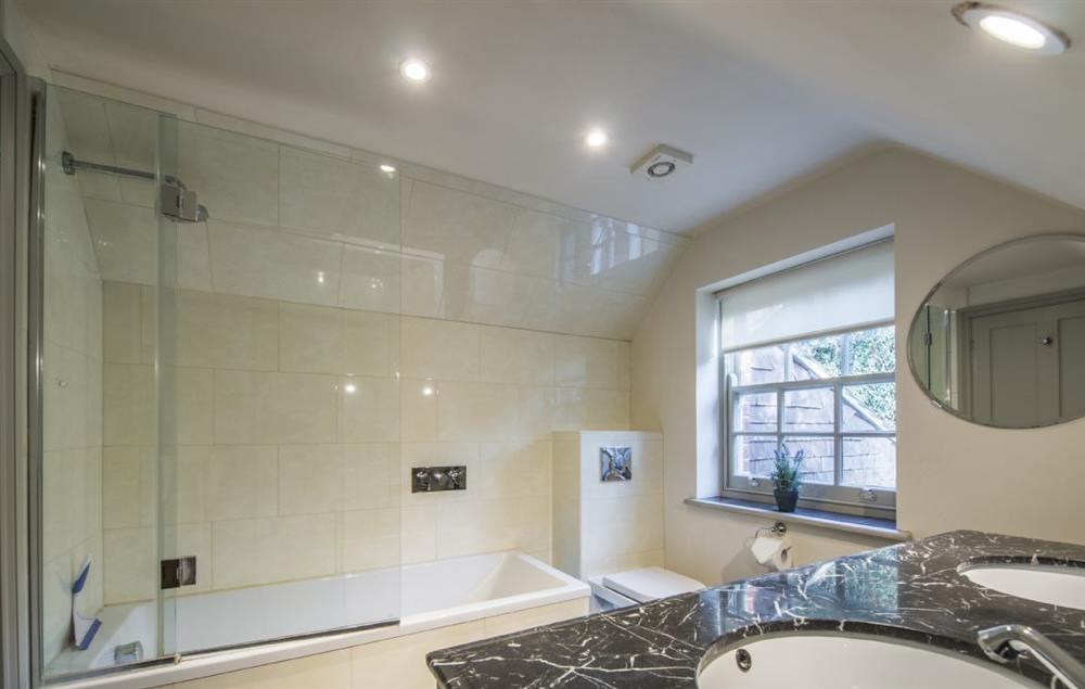 Bathroom with twin basins, bath and shower over at Coach House (Kent), Nr Sevenoaks