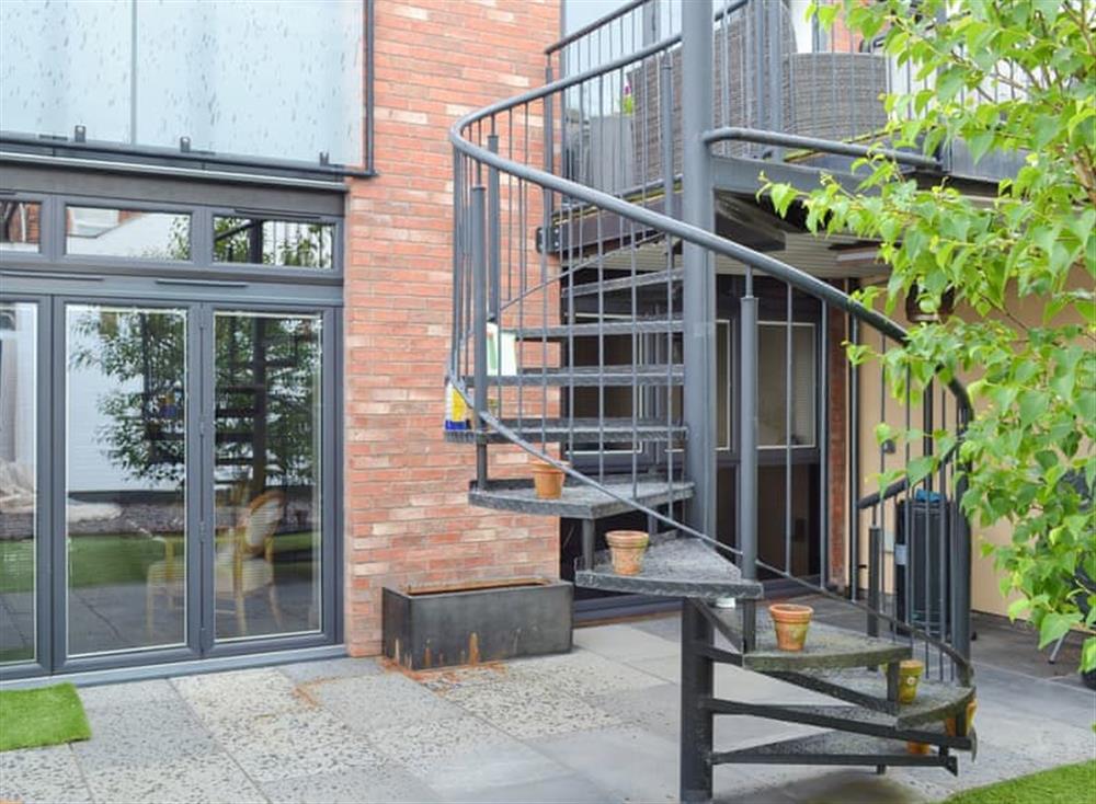 Courtyard entrance with spiral stairs to terrace at Coach House in Lytham St Annes, Lancashire