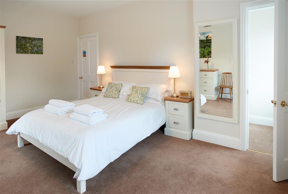 Bedroom one with a 5’ king-size bed (photo 2) at Coach House, Netherby Hall, Longtown