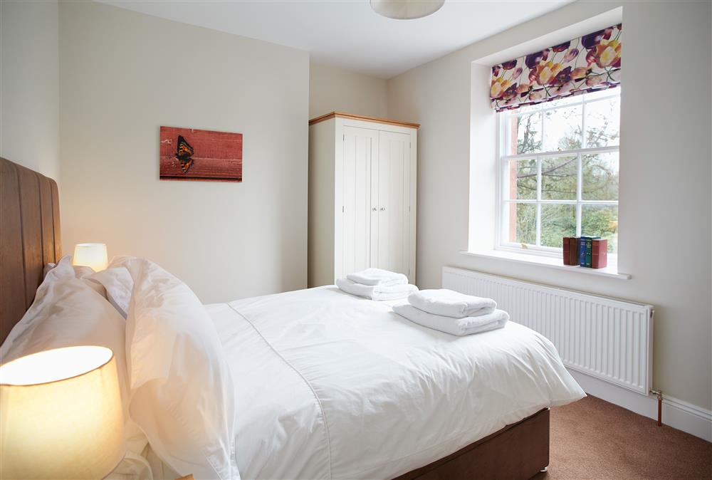 Bedroom two with a double 4’6 bed at Coach House, Netherby Hall, Longtown
