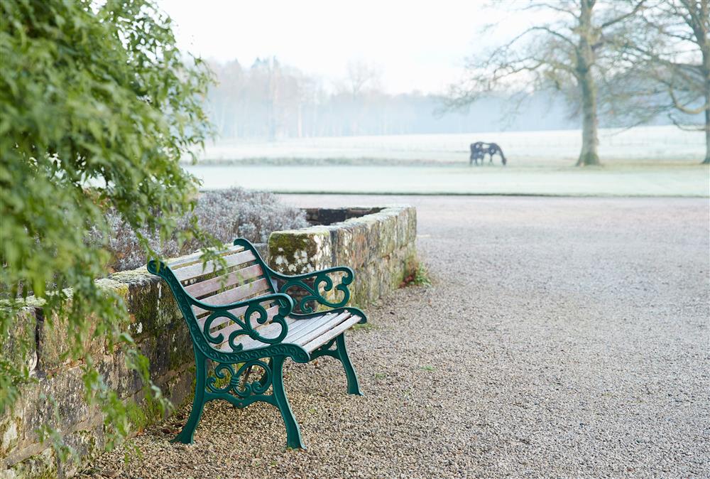 One of the many seating areas dotted around the grounds at Coach House, Netherby Hall, Longtown