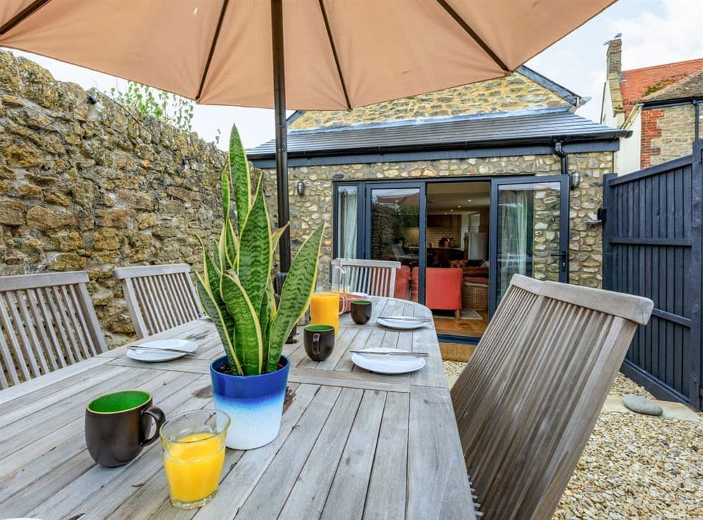 Outdoor eating area at Coach House Retreat in Burton Bradstock, near Bridport, Dorset