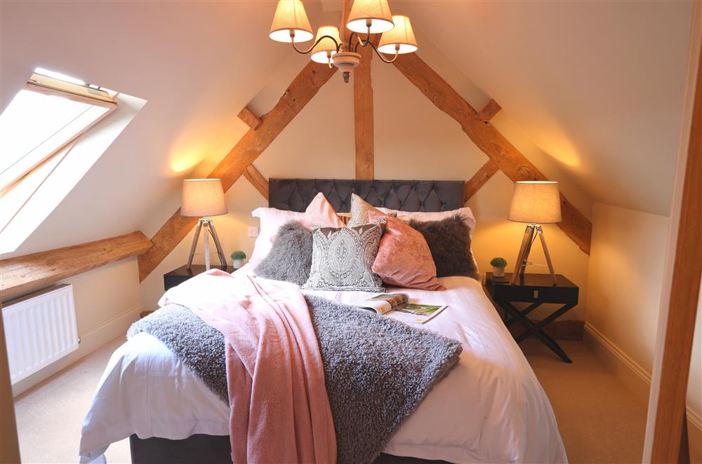 Bedroom two on the first floor, with a 5’ king-size bed and beautiful exposed beams at Coach House, Walton, Near Stratford-upon-Avon