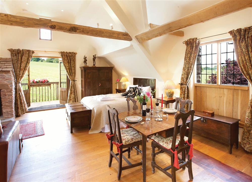 Open-plan dining and sleeping area at Coach House (Worcestershire), Fishpools