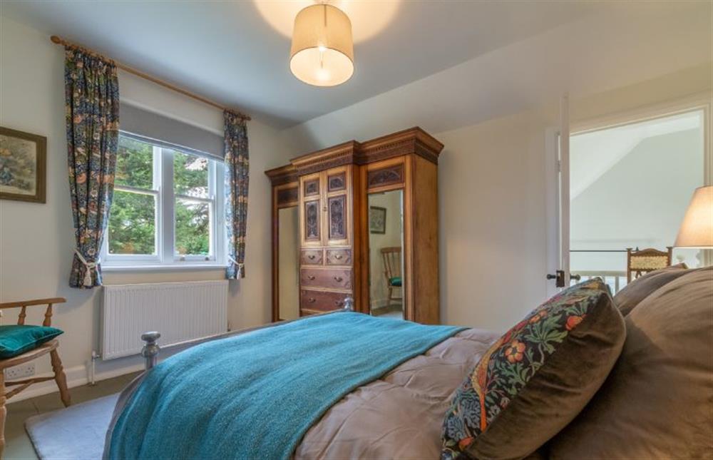 First floor: Master bedroom with large wardrobe at Coachmans Cottage, Old Hunstanton