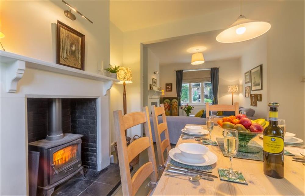 Ground floor: Dining area with wood burning stove at Coachmans Cottage, Old Hunstanton