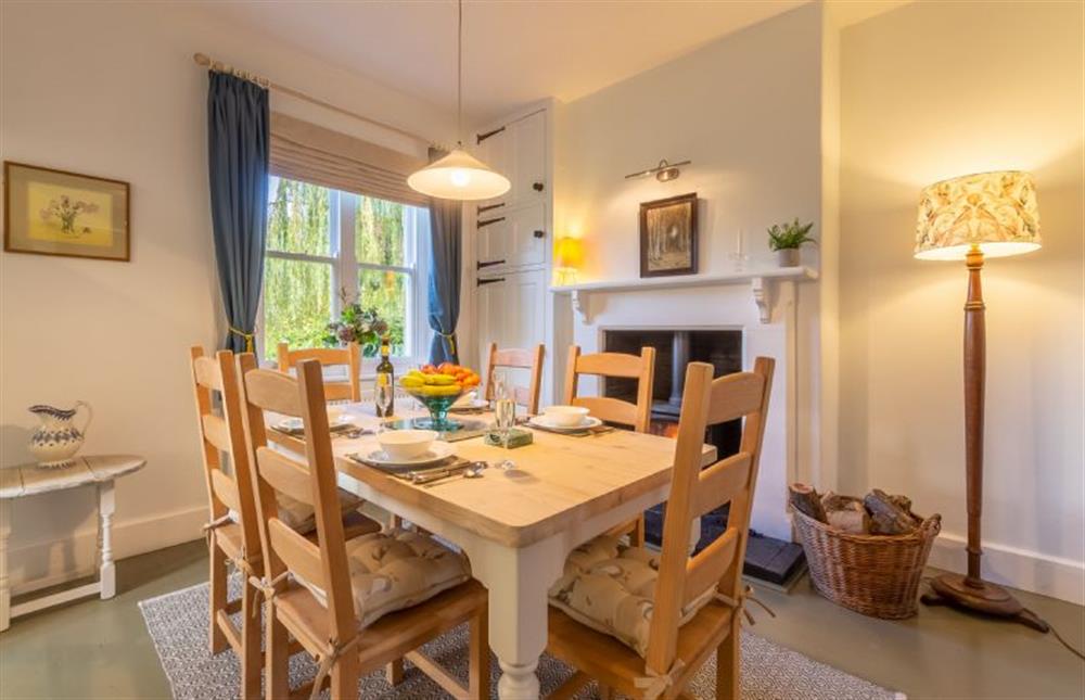 Ground floor: Dining room with wood burning stove at Coachmans Cottage, Old Hunstanton