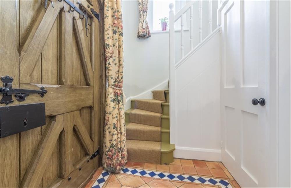 Ground floor: Entrance hallway with stairs to first floor and cloakroom at Coachmans Cottage, Old Hunstanton
