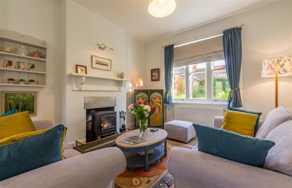 Ground floor: Sitting room with electric stove at Coachmans Cottage, Old Hunstanton