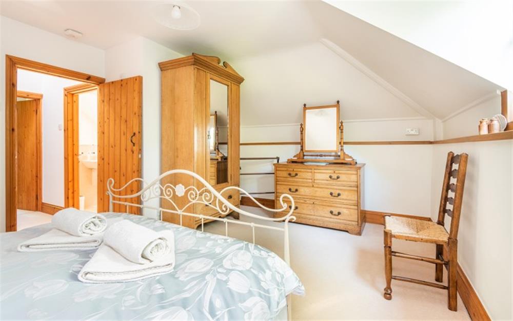 Main bedroom with king bed at Coachmans Cottage in St Kew