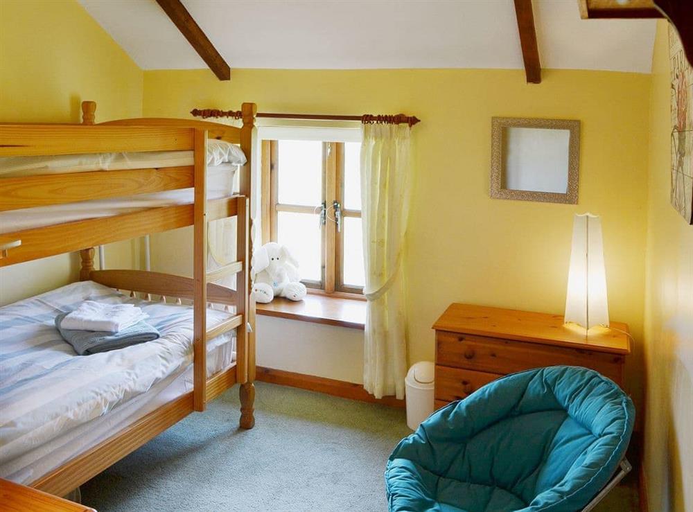 A charming bunk bedded room is perfect for young children at Coachmans Cottage in White Cross, near Newquay, Cornwall