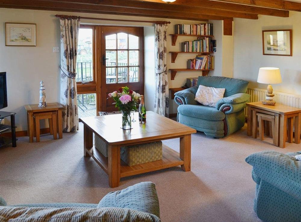 The spacious lounge is furnished comfortably at Coachmans Cottage in White Cross, near Newquay, Cornwall