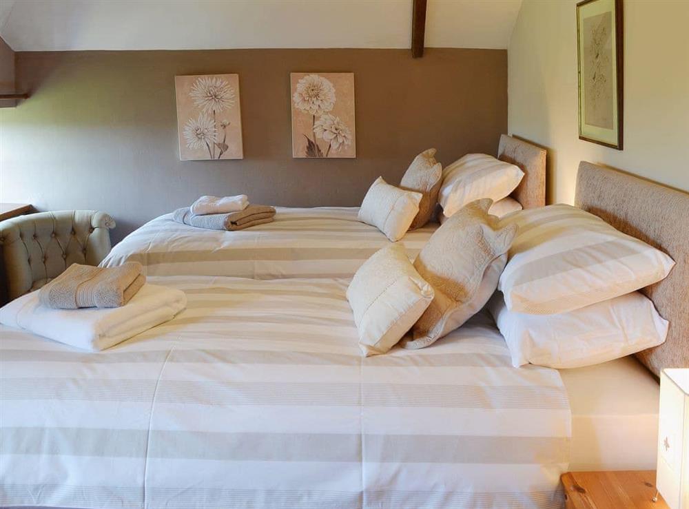 Whilst having sloping ceilings the double bedroom is spacious at Coachmans Cottage in White Cross, near Newquay, Cornwall