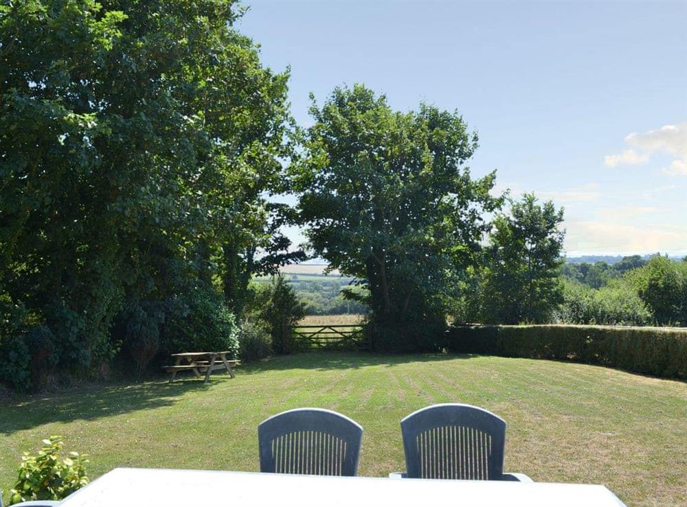 Lawned garden and wonderful views beyond at Coachmans Retreat in Pennytinney, St Kew., Cornwall