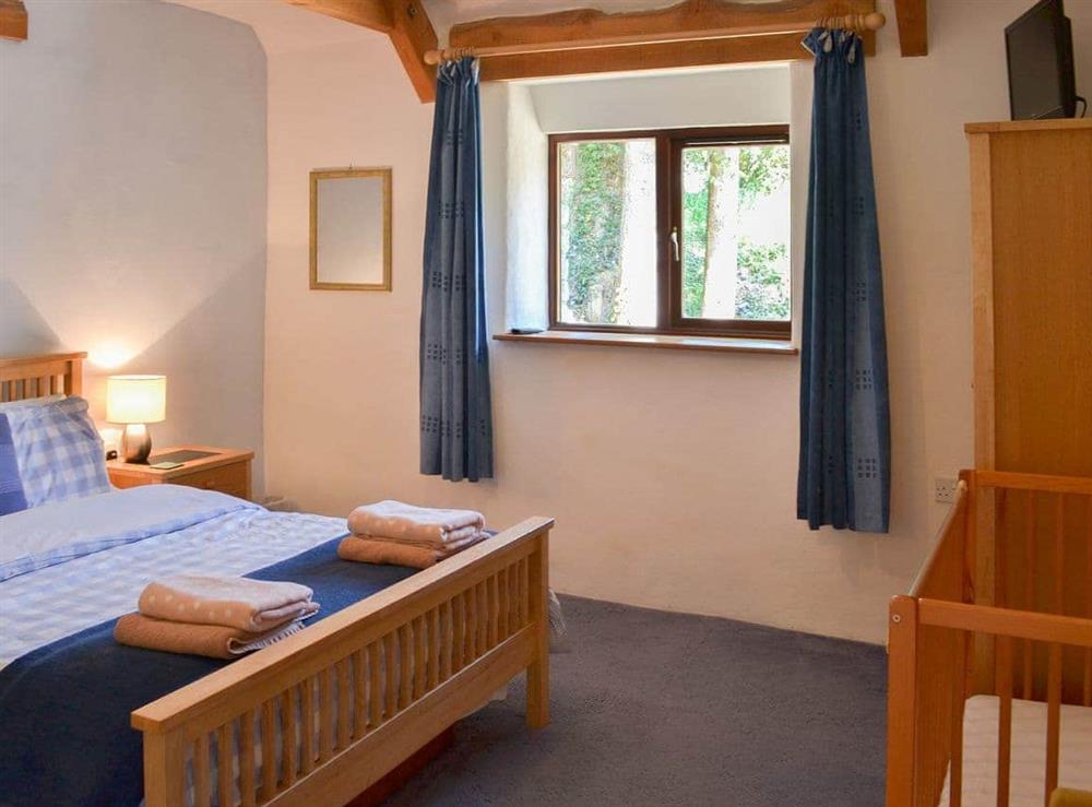 Welcoming double bedroom with additional cot at Coachmans Retreat in Pennytinney, St Kew., Cornwall