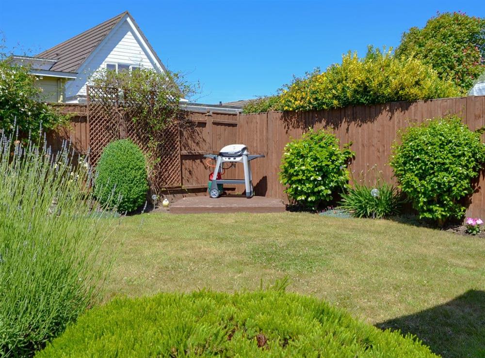 Delightful lawned rear garden at Coastal Dream in Mudeford, near Christchurch, Dorset