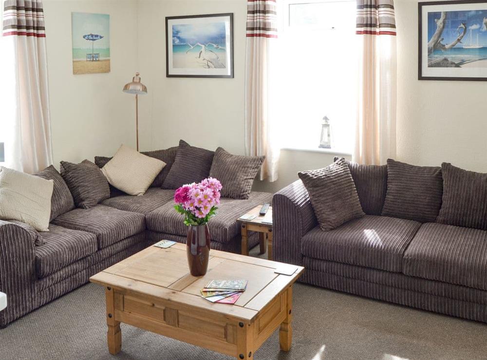 Comfortable seating area within the living room at Coastguard Cottage in Caister-on-Sea, near Great Yarmouth, Norfolk