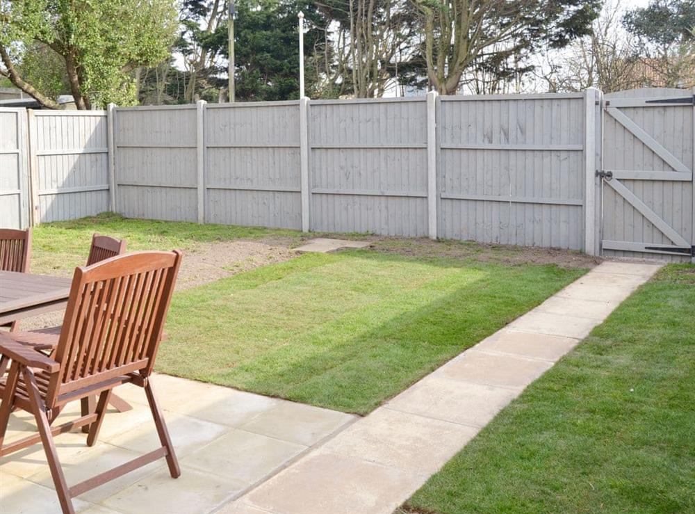 Enclosed lawned garden at Coastguard Cottage in Caister-on-Sea, near Great Yarmouth, Norfolk