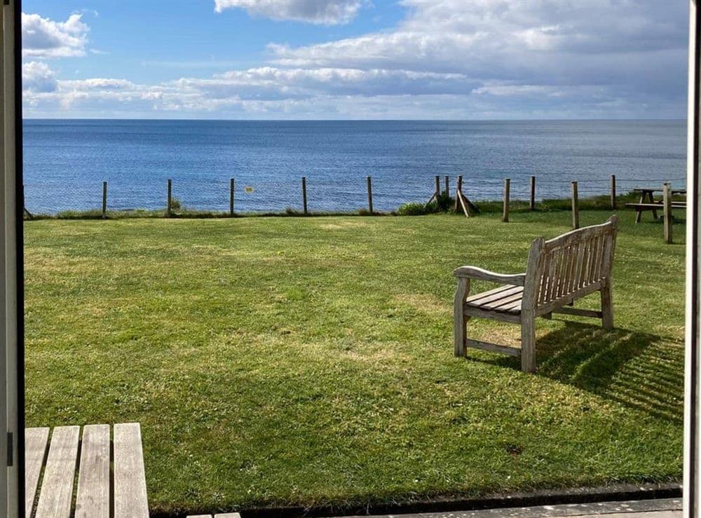 View from the door over the garden to the sea at Coastguard Cottage in Downderry, near Looe, Cornwall