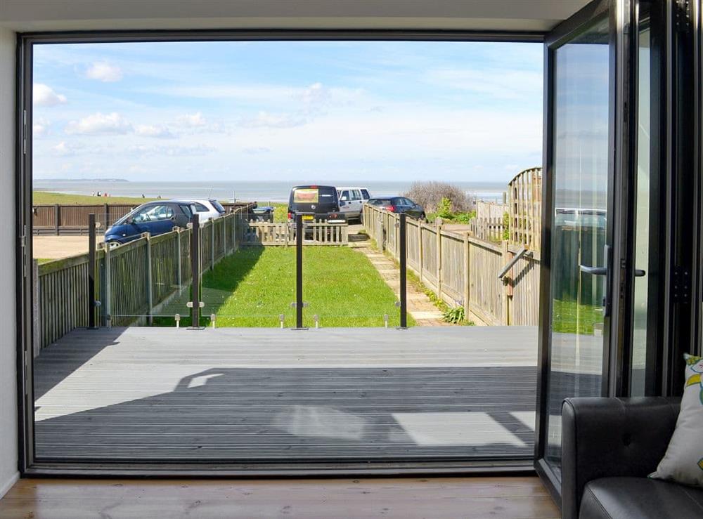 Bi-fold doors opening onto decking with wonderful views overlooking the Thames Estuary. at Coastguard Cottage in Swalecliffe, near Whitstable, Kent