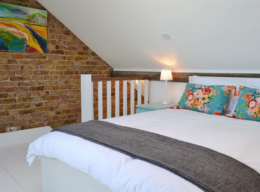 Exposed brickwork and smart decor in the double bedroom at Coastguard Cottage in Swalecliffe, near Whitstable, Kent