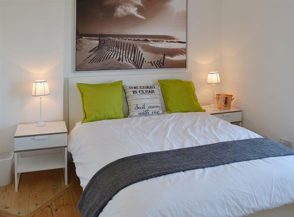The master bedroom is comfortable and well-furnished at Coastguard Cottage in Swalecliffe, near Whitstable, Kent