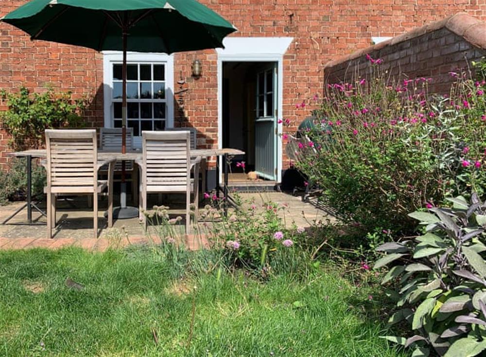 Front garden and patio area at Coastguards Cottage in Burnham Overy Staithe, near Burnham Market, Norfolk