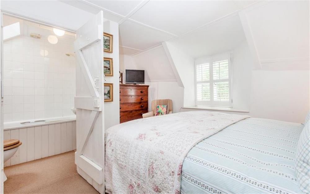 Another view of the master bedroom showing door to en suite and TV at Cob Cottage in Kingsbridge