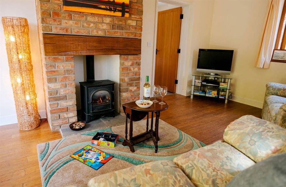Relax in the living area at Cob Cottage in Rhosilli, Swansea, Glamorgan, West Glamorgan