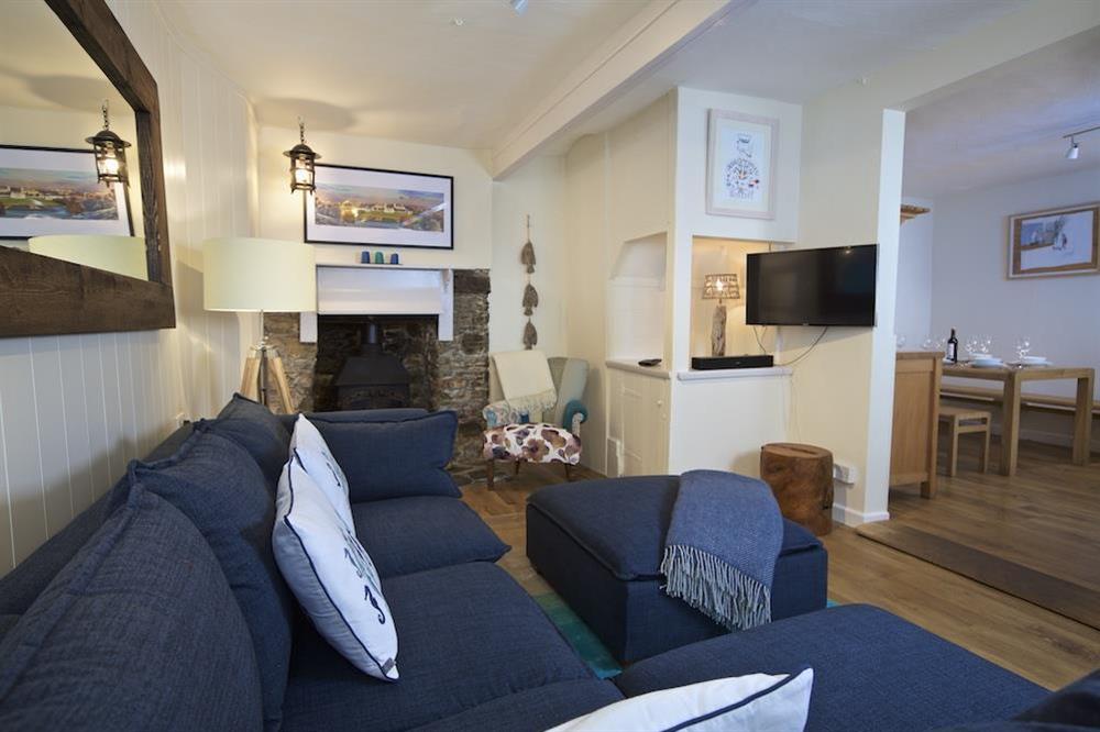 Cosy living room leading into the open plan kitchen diner at Cob Cottage in , Salcombe