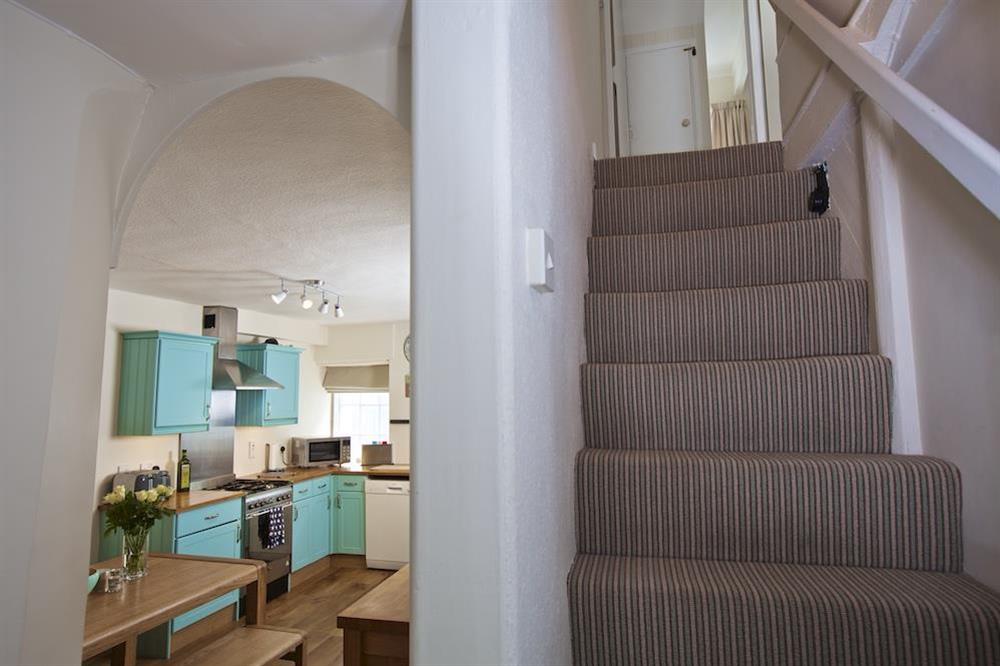Stairs leading to double bedroom and snug room at Cob Cottage in , Salcombe