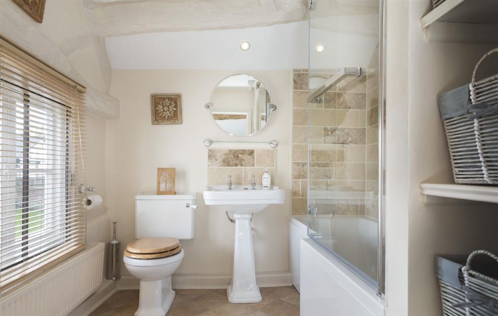 Family bathroom with bath and electric shower over at Cobblers Cottage, Pembridge