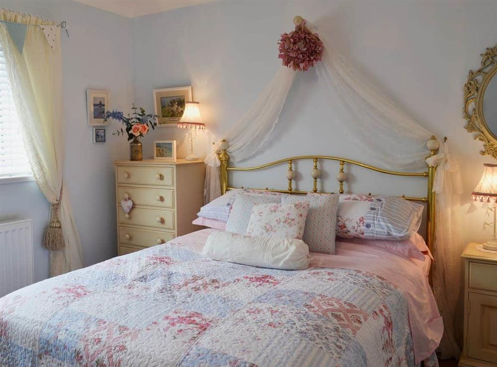 Relaxing bedroom with kingsize bed at Coble Cottage in Filey, Yorkshire, North Yorkshire