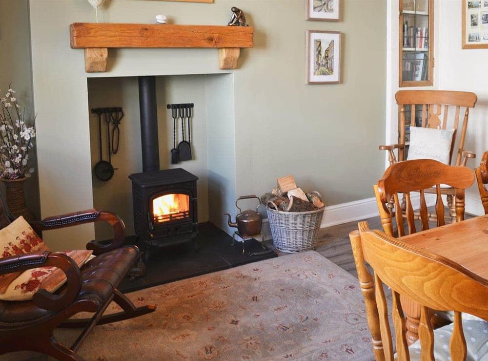 Dining room with log burner at Coble Cottage in Flamborough, North Humberside