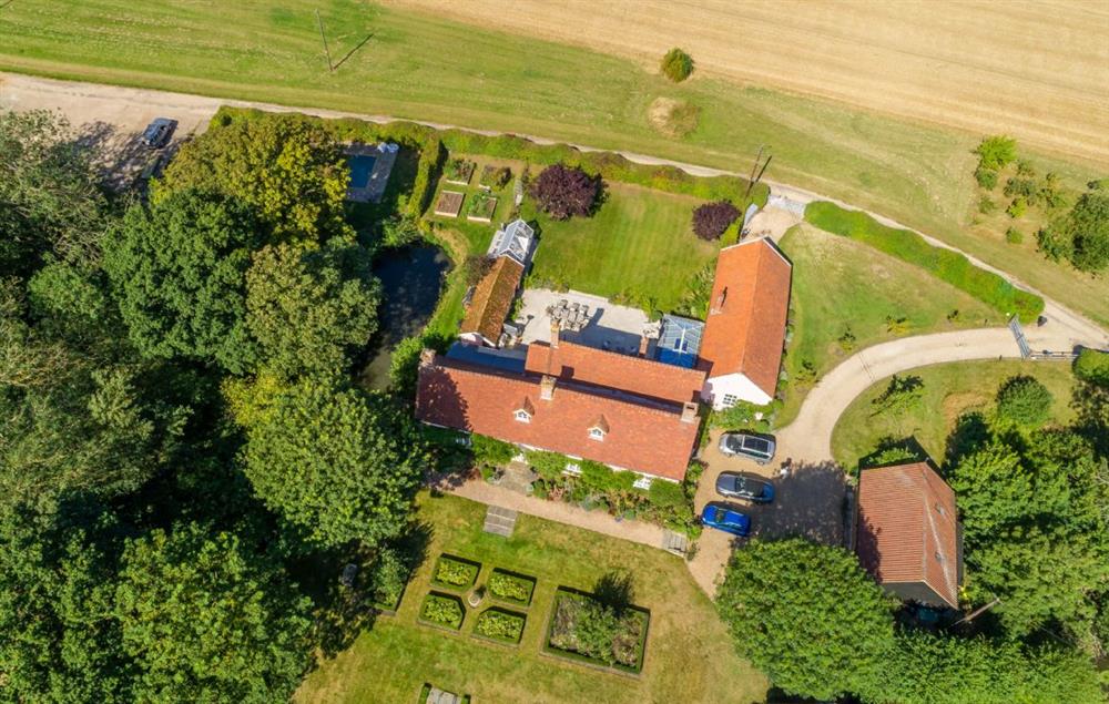 Aerial view of the hall with surrounding gardens at Cockerells Hall, Buxhall