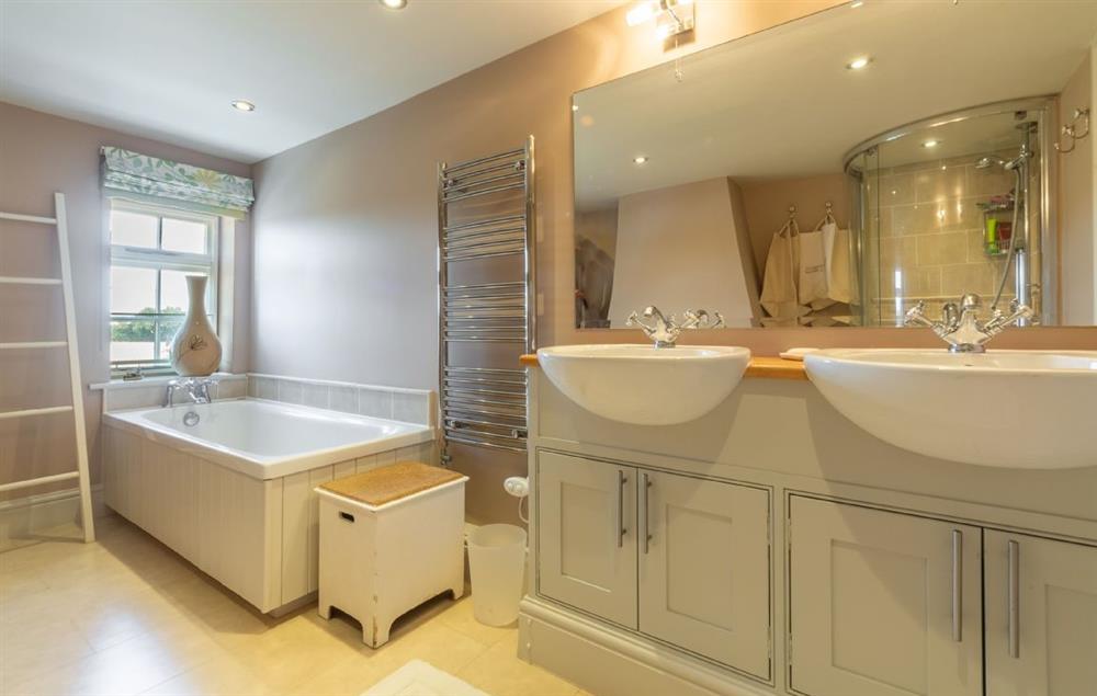 Family bathroom with separate bath and shower and his and hers wash basins at Cockerells Hall, Buxhall