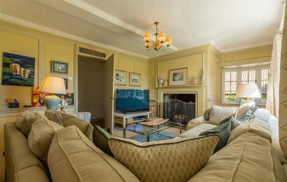 Snug with open fire, paneled walls and television (photo 3) at Cockerells Hall, Buxhall