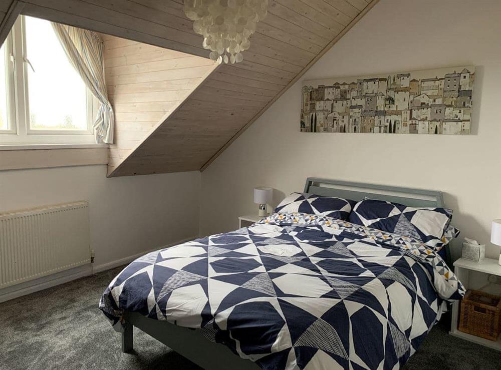 Double bedroom with dormer window with spectacular views out to sea at Cockleshell Cottage in Haverigg, near Millom, Cumbria
